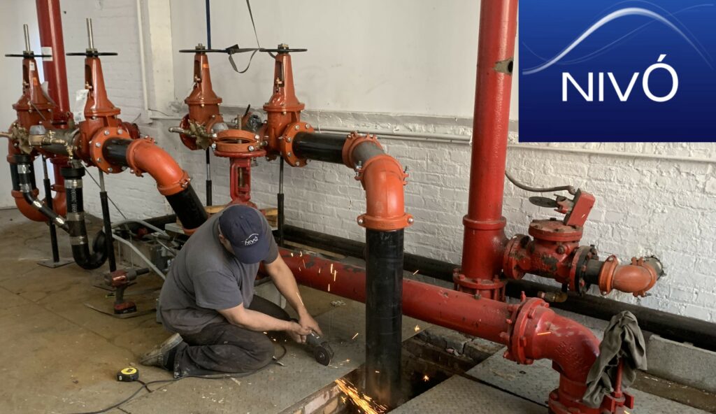 Staff installing a backflow